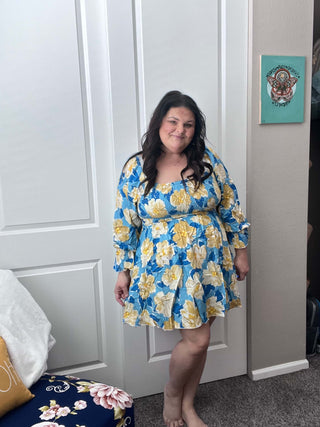 Woman wearing the Sabrina Smocked Bell Sleeve Dress, styled for a chic and feminine look perfect for casual outings or special occasions.