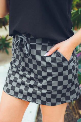 Close-up view of the checkered pattern and fabric of the Check Back Checkered Skort, highlighting its comfortable and functional design.