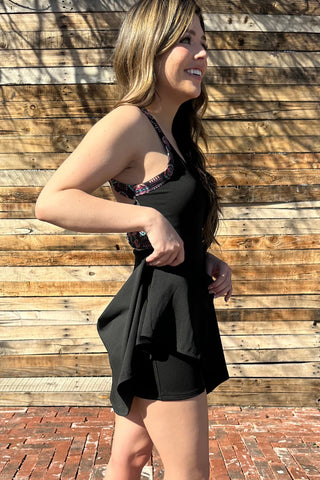 Side view of lightweight fabric and flattering cut of the Small Town Girl Tennis Dress, showing shorts.