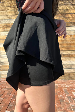 Side view of lightweight fabric and flattering cut of the Small Town Girl Tennis Dress, showing shorts.