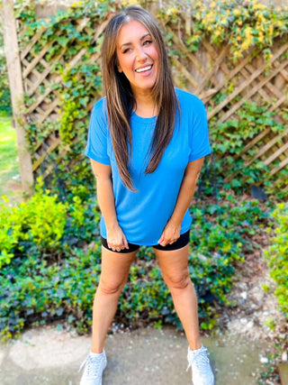 Woman wearing the Basic V-Neck Tee, styled casually for a simple, chic look.