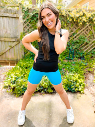 Woman wearing the Sasha Suck & Tuck Biker Short, styled for a chic, comfortable look.