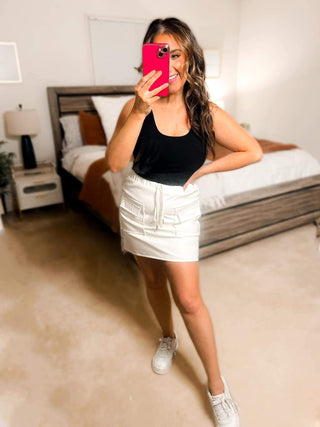 Close-up view of the cargo details and vegan leather texture of the Campbell Cargo Vegan Leather Mini Skirt