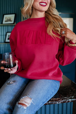 Woman wearing the Wine Embossed Sweatshirt, styled casually for a cozy, chic look.