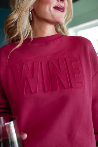 Woman wearing the Wine Embossed Sweatshirt, styled casually for a cozy, chic look.