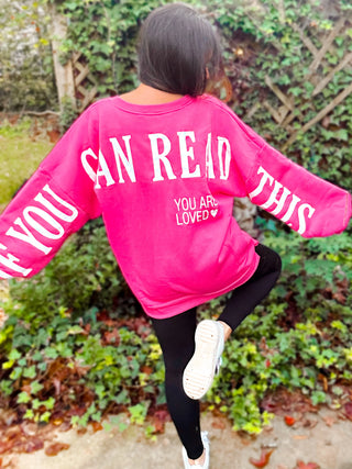 Woman wearing the ‘If You Can Read This’ Spring Scuba Sweatshirt, styled casually for a playful and relaxed look.