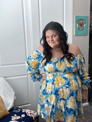 Woman wearing the Sabrina Smocked Bell Sleeve Dress, styled for a chic and feminine look perfect for casual outings or special occasions.