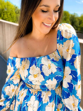 Woman wearing the Sabrina Smocked Bell Sleeve Dress, styled for a chic and feminine look perfect for casual outings or special occasions.