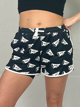 Close-up view of the pom-pom details and drawstring waistband on the Shake Your Pom Poms Drawstring Everyday Shorts.