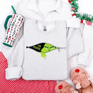 White sweatshirt with Grinch design, tumbler, and red checkered pants on a white background