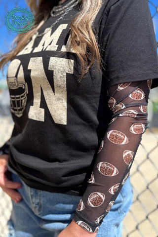 Woman wearing the Football Mesh Top, styled casually with jeans or athletic gear for a sporty, chic look."