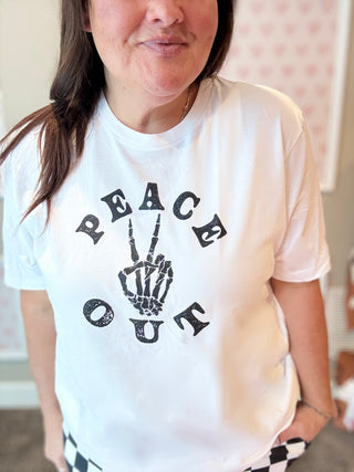 Person wearing a white t-shirt with a black graphic design