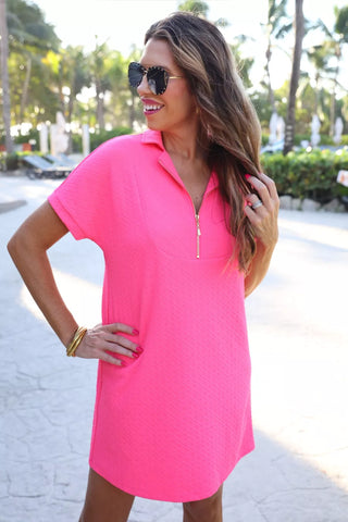 Front view of textured zipper dress with sleek silhouette and confident, modern style.
