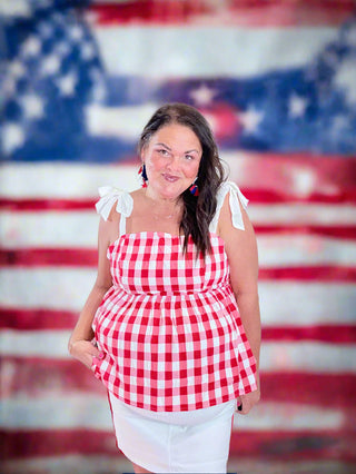 Patriotic Plaid Babydoll Top – Sweet As Apple Pie Top featuring a classic plaid design with adjustable tie straps and a comfortable smocked back.