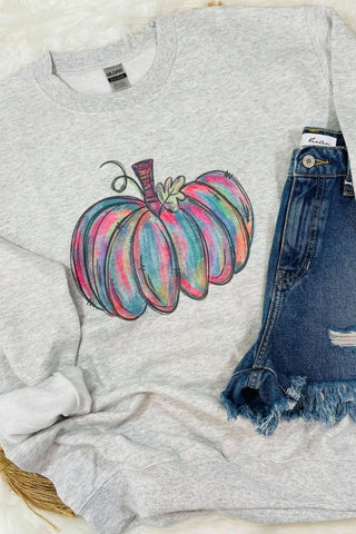Gray sweatshirt with a colorful pumpkin design and denim shorts on a light background