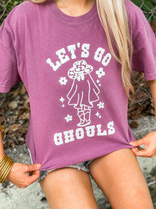 Purple t-shirt with 'Let's Go Ghouls' graphic and text worn by a person.