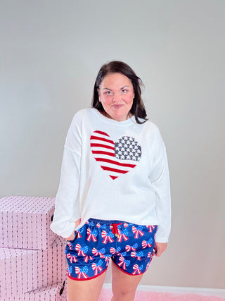 American Heart Flag Sweater – Oversized mid-weight knit sweater with a patriotic American flag heart design, perfect for showing American pride in cozy style.