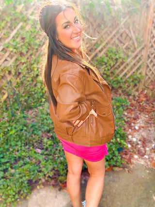 Woman wearing the Ollie Oversized Vegan Leather Biker Jacket, styled for an edgy, chic look with denim or skirts.