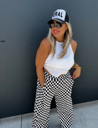 Woman wearing the Bold Block Checker Pants, styled casually with a top for a bold, trendy look.
