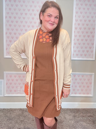 Chocolate brown ribbed jumper dress with soft, stretchy fabric — perfect for layering over mesh tops or sweaters for cozy fall style.