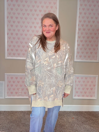 Soft camo print crew pullover with exposed seams, ribbed trim, and split cuff hem — oversized, slouchy fit with cozy sweatshirt interior.