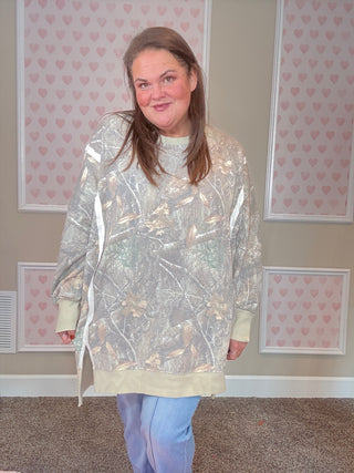 Soft camo print crew pullover with exposed seams, ribbed trim, and split cuff hem — oversized, slouchy fit with cozy sweatshirt interior.