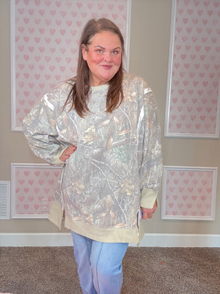 Soft camo print crew pullover with exposed seams, ribbed trim, and split cuff hem — oversized, slouchy fit with cozy sweatshirt interior.