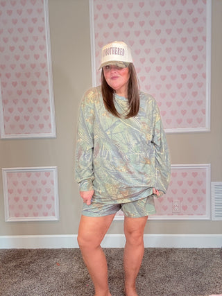 Soft camo lounge set with long sleeve top featuring pocket detail and matching elastic waistband shorts — cozy, stretchy, and perfect for everyday comfort.
