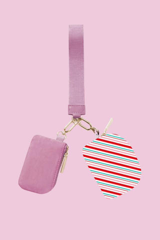 Candy stripe wristlet pouch with wrist strap and zipper closure, a trendy women’s accessory that pairs perfectly with women’s clothing and fashion trends.