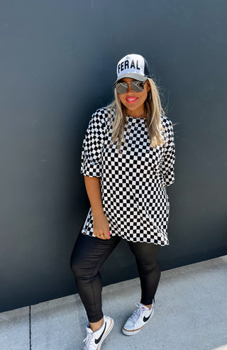 Woman wearing the Check Me Out Side Split Top, styled casually with jeans or a skirt for a trendy, laid-back look.