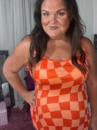 Woman wearing the Bishop Checkered Bodycon Dress, styled for a chic, bold look perfect for a night out or event.