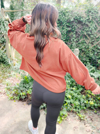 Woman wearing the Madeline Midi Balloon Sleeve Sweatshirt styled casually for a chic, comfortable look.