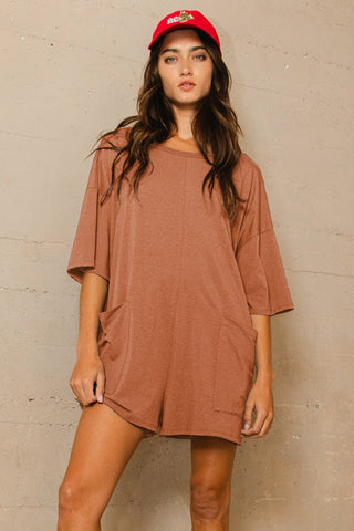 Model wearing Crew Neck V-Back Romper featuring oversized fit and buttery-soft fabric for all-day comfort.