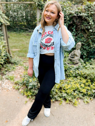 Woman wearing the Delaney Distressed Denim Shacket, styled casually with jeans or leggings for a cool, effortless look.