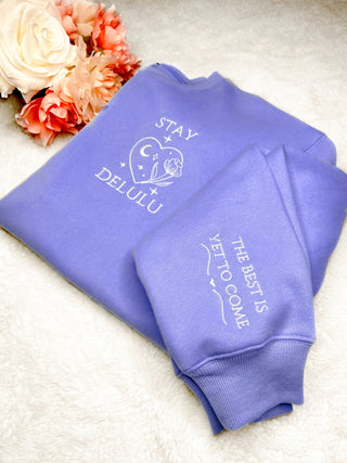 Close-up view of the 'Delulu' graphic and scuba fabric of the Stay Delulu Scuba Sweatshirt.