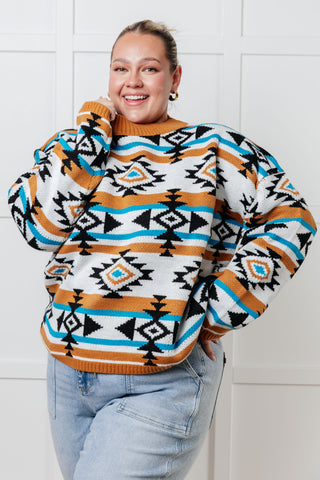 Person wearing a patterned sweater with a white tiled background