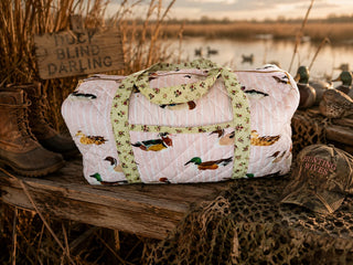 Blakeley pink duck print quilted weekender bag with zip closure, interior pocket, and spacious travel design.