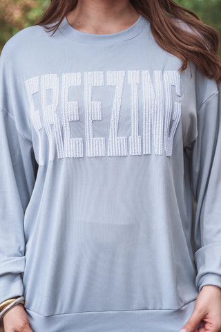 Close-up view of the ribbed fabric and cute embroidered design on the Freezing Embroidered Ribbed Pullover.