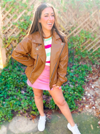 Woman wearing the Ollie Oversized Vegan Leather Biker Jacket, styled for an edgy, chic look with denim or skirts.