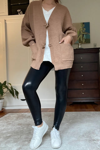 Glossy Faux Leather Leggings displayed flat, showcasing their sleek, shiny texture and flattering cut.