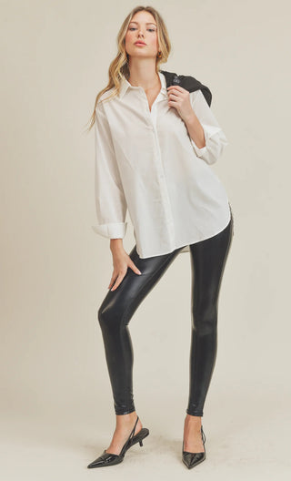 Woman wearing the Glossy Faux Leather Leggings styled with a top for a bold, fashion-forward look.