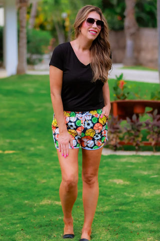 Woman wearing the Go Team Multi Sport Drawstring Everyday Shorts, styled casually with a sporty top for an active, laid-back look.
