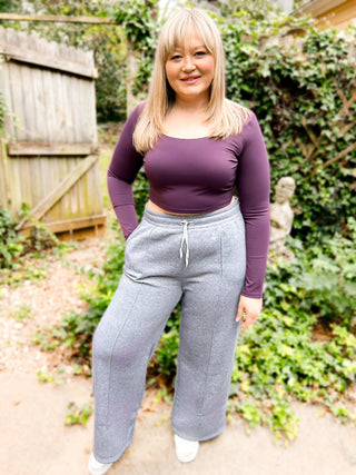 Woman wearing the Polly Pinstripe Wide Leg Scuba Sweatpants styled casually for a chic, elevated look.