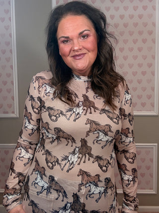 Sheer mesh top with western horse motif print and lettuce hem detail layered over cami for trendy boutique outfit.