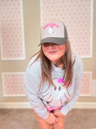 Woman wearing a gray cap with 'Boo Crew' text and a gray sweatshirt with a ghost design.
