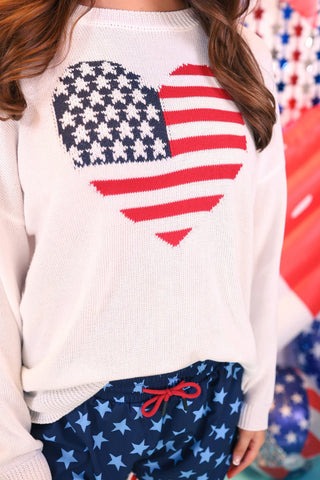 Model wearing the American Heart Flag Sweater featuring a heart-shaped flag design on a cozy knit.