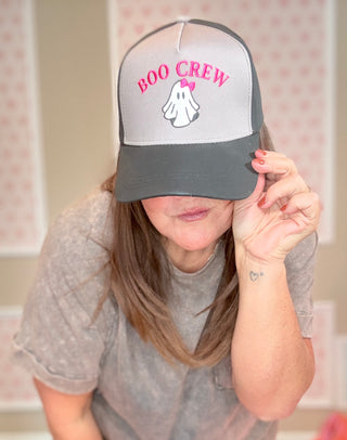 Person wearing a cap with 'BOO CREW' text and ghost graphic, indoors.