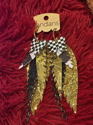 Decorative brooch with gold, black, and white elements on a red textured background