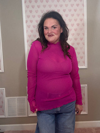 Magenta glitter mesh long sleeve top for women with sheer fabric, subtle sparkle, and fitted silhouette, perfect for layering with trendy clothes and chic mom-approved looks.
