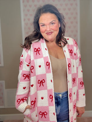 Valentine’s edition cloud cardigan for women featuring ultra-soft cozy fabric with a checkered pattern and bow details, perfect for comfy mom style and chic mom-approved looks.